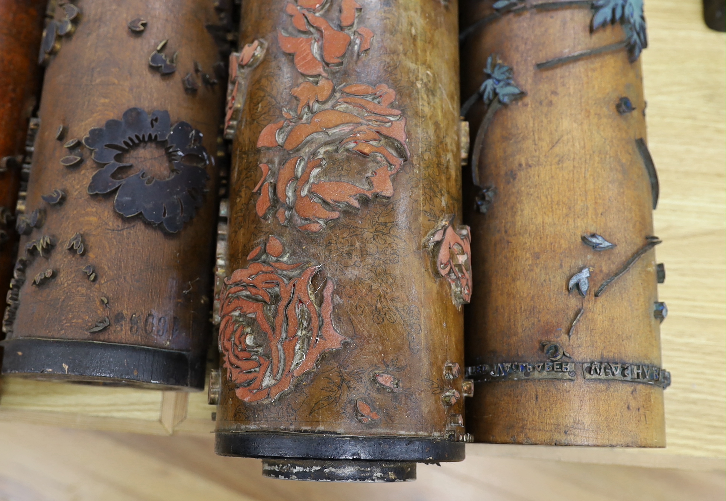 Five USA wooden print rollers for wallpaper, late 19th century, including a UWPC (United Wall Paper Craftsmen of North America) example, another stamped with serial numbers, longest 60.5cm